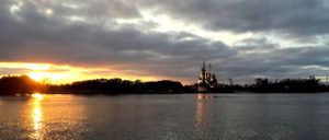 View of Battleship from riverwalk in downtown Wilmington at Sunset